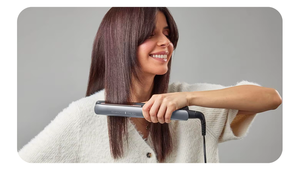 a young woman uses the remington hair straighteners on her hair