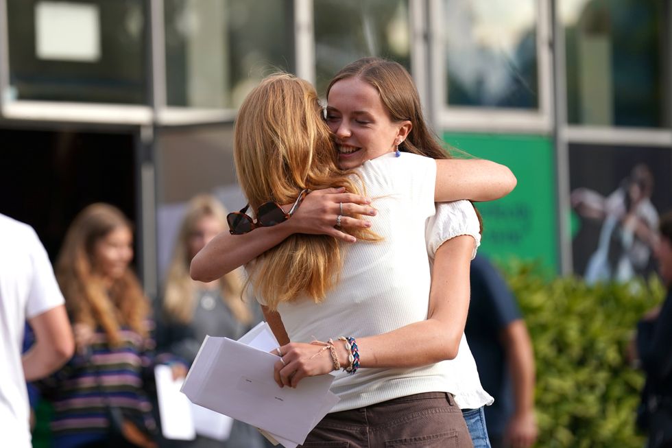 Abi Hill hugging a person after reading their A-level results at Norwich School, Norwich. Picture date: Thursday August 18, 2022.
