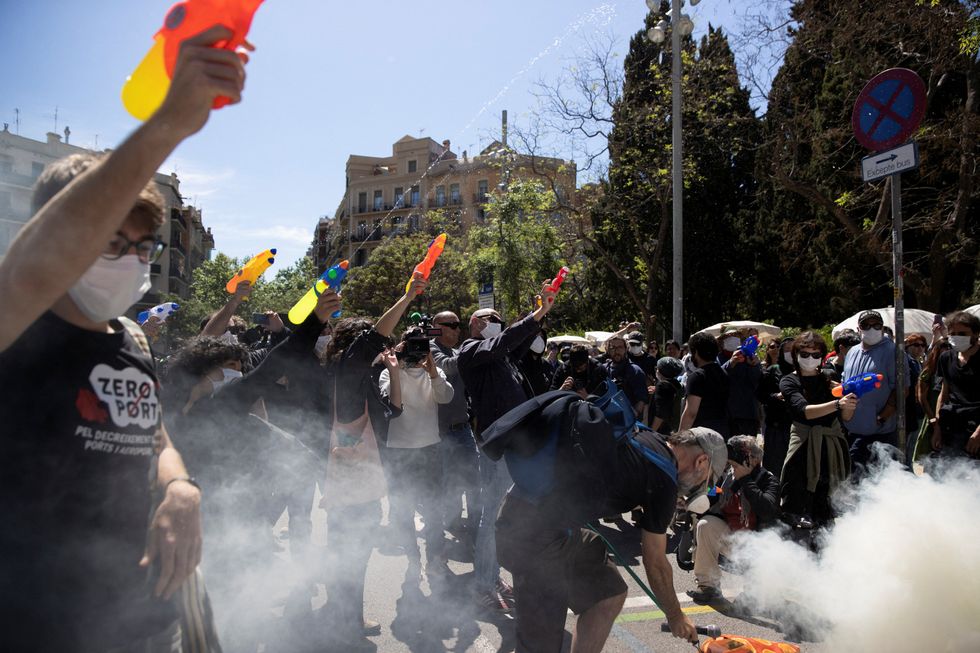 Acitivists stop a tourist bus with water pistols, in front of La Sagrada Familia Basilica