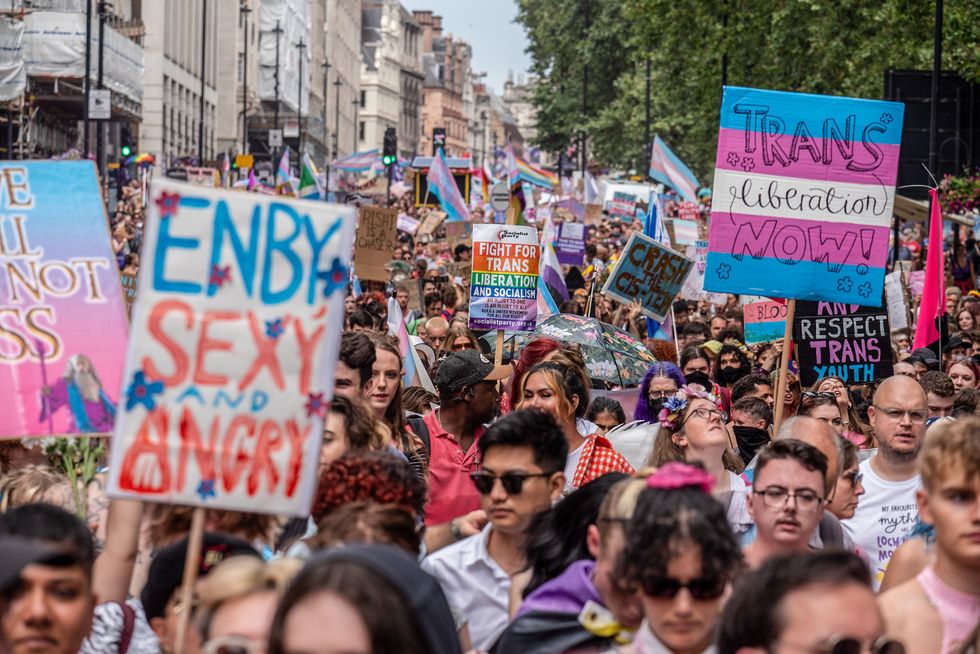 Activists and protesters hold placards expressing their opinion during the demonstration