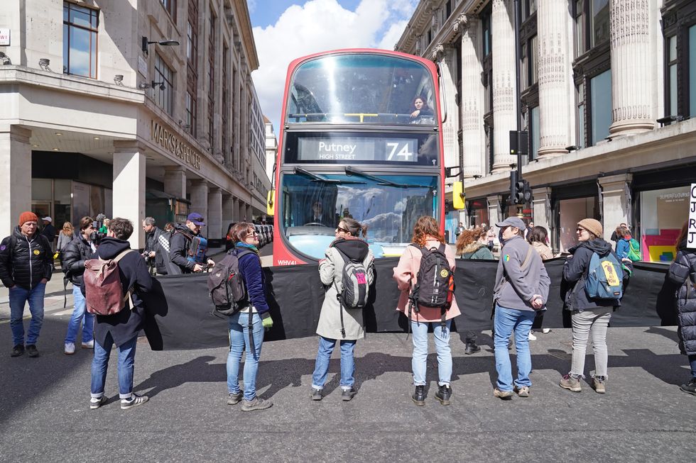Activists from Extinction Rebellion demonstrate on Oxford Street in central London. Picture date: Saturday April 9, 2022.