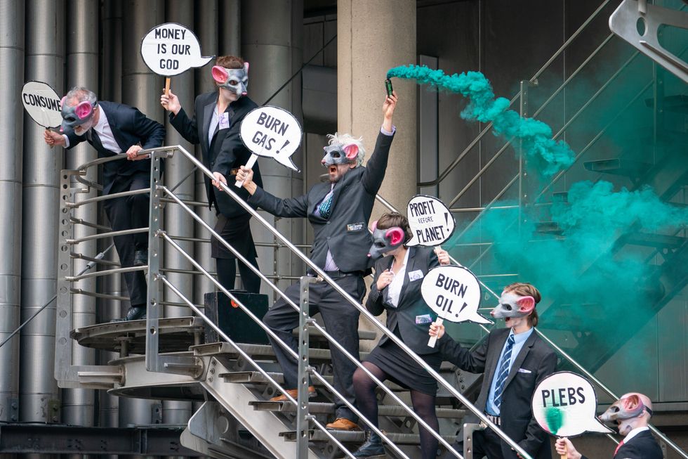Activists from Extinction Rebellion stand on a stairwell at Lloyds of London, in the City of London, as they call for Lloyds to stop insuring fossil fuel projects worldwide. Picture date: Tuesday April 12, 2022.
