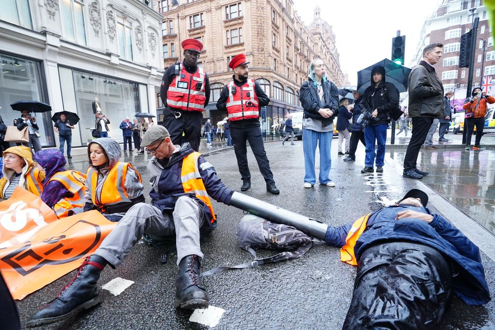Activists from Just Stop Oil during their protest outside Harrods department store in Knightbridge, London. Picture date: Thursday October 20, 2022.