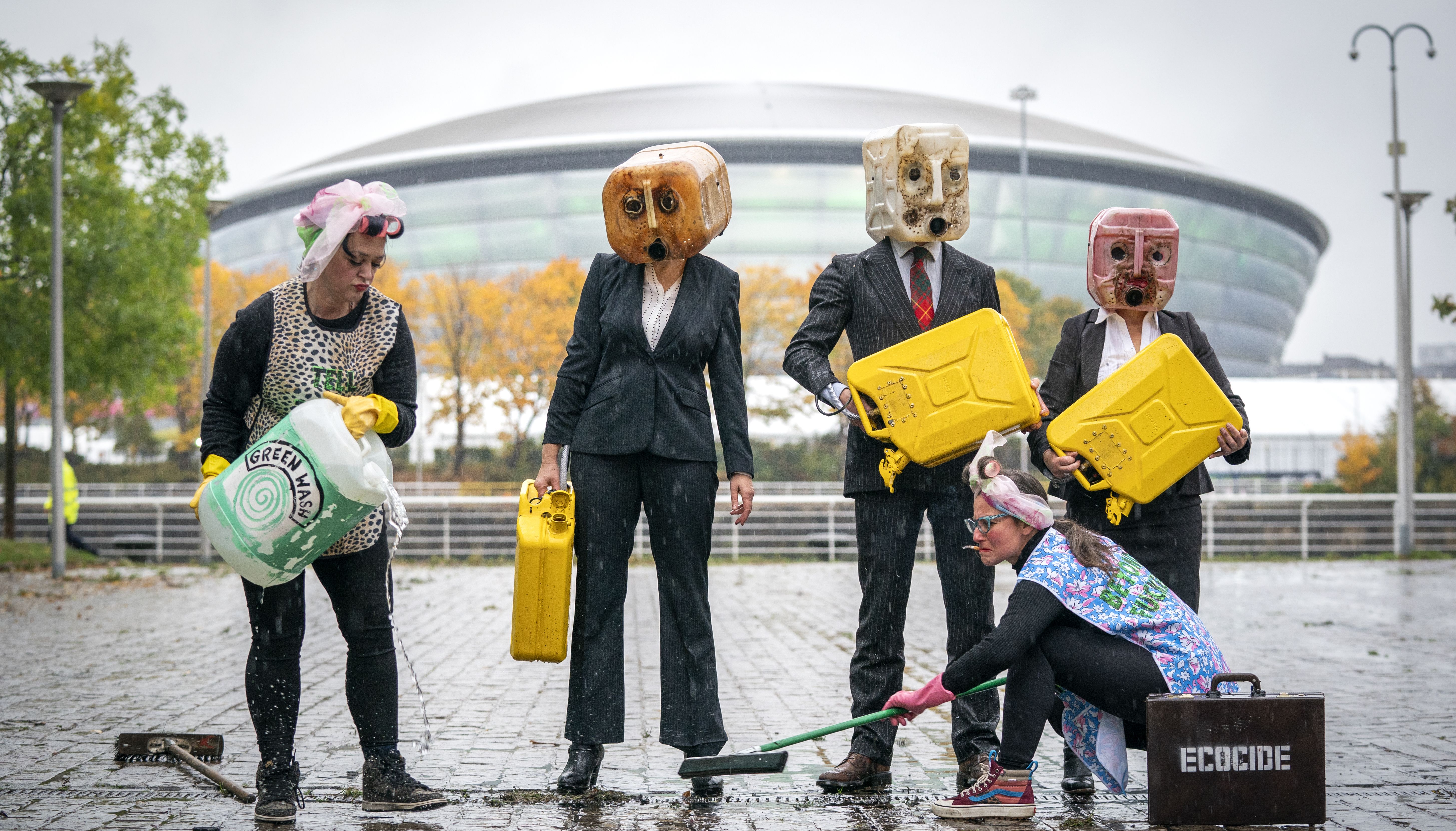 Activists from Ocean Rebellion wearing oil heads with 75-litres of fake oil, in front of the Hydro, Glasgow, as the city prepares for the Cop26 conference.