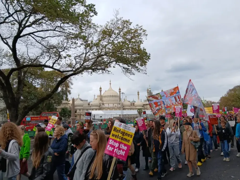 Activists wave the 'New Union Flag' at a Stand Up To Racism march