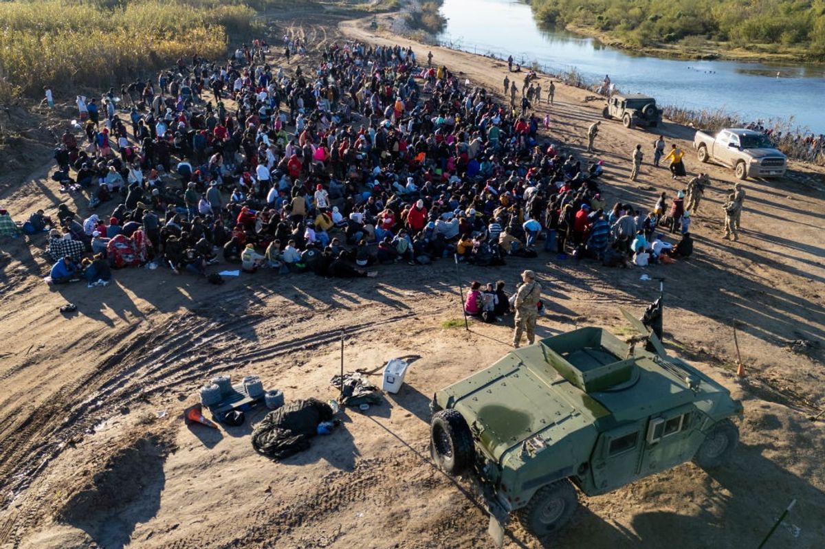 aerial view Texas National Guard troops watch over some of more than 1,000 immigrants who had crossed the Rio Grande 