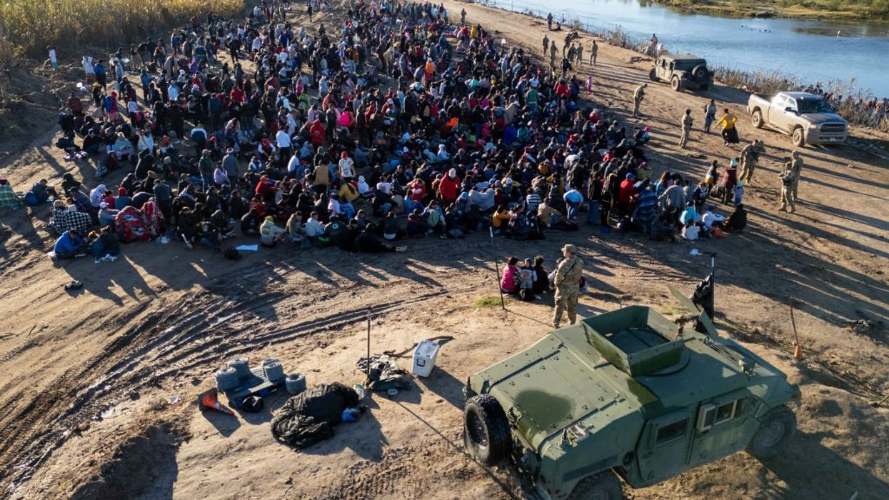 aerial view Texas National Guard troops watch over some of more than 1,000 immigrants who had crossed the Rio Grande