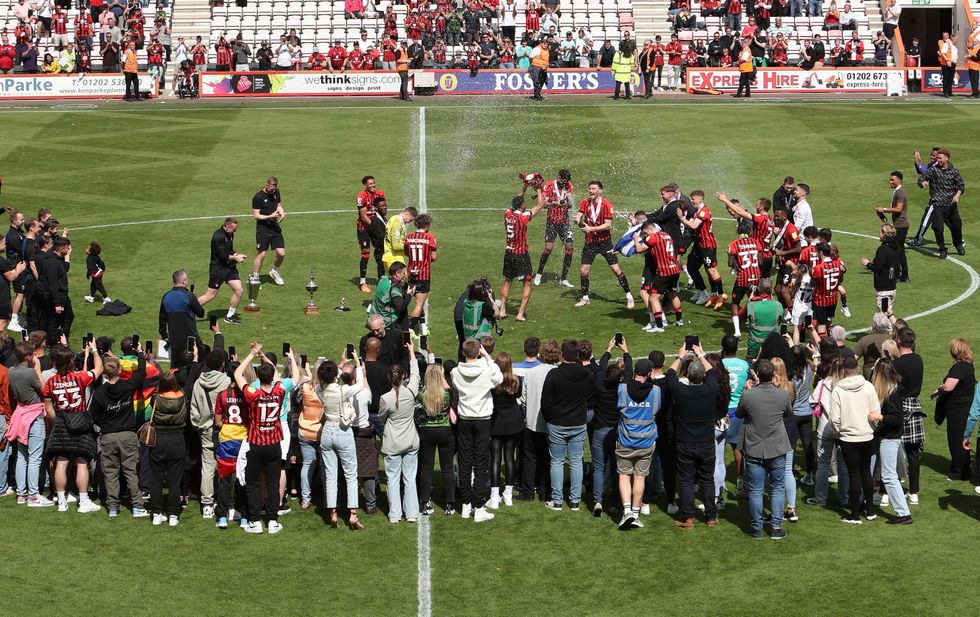 AFC Bournemouth players celebrate being promoted to the Premier League after the final whistle in the Sky Bet Championship match at the Vitality Stadium, Bournemouth. Picture date: Saturday May 7, 2022.