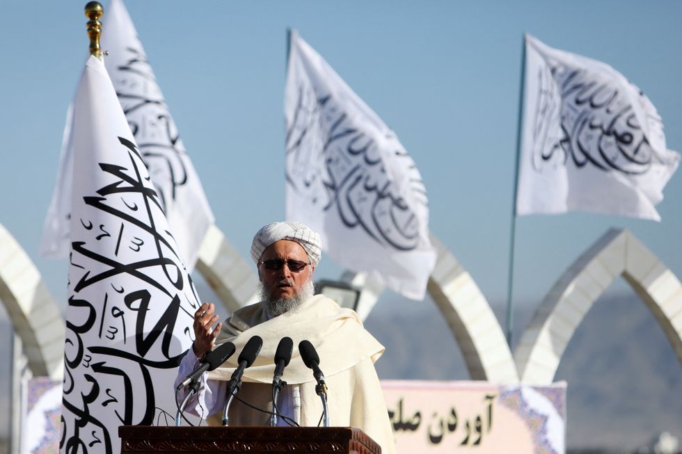 Afghan Deputy Prime Minister Mawlavi Abdul Salam Hanafi speaks during a ceremony to raise the Taliban flag in Kabul, Afghanistan, March 31, 2022