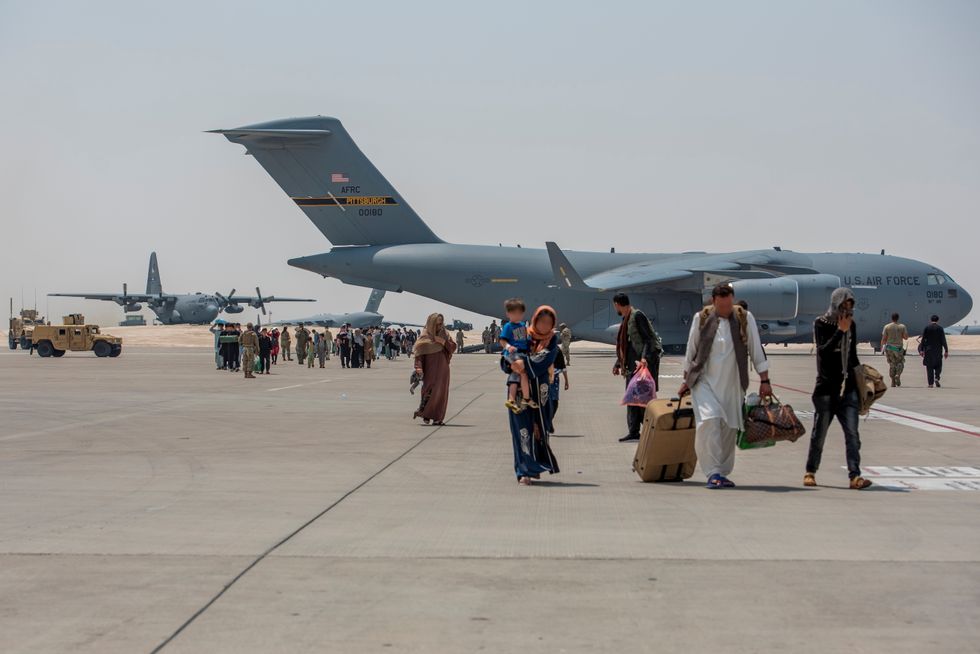 Afghan evacuees debark a C-17 Globemaster lll August 23, 2021, at Al Udeid Air Base, Qatar. Picture taken August 23, 2021.