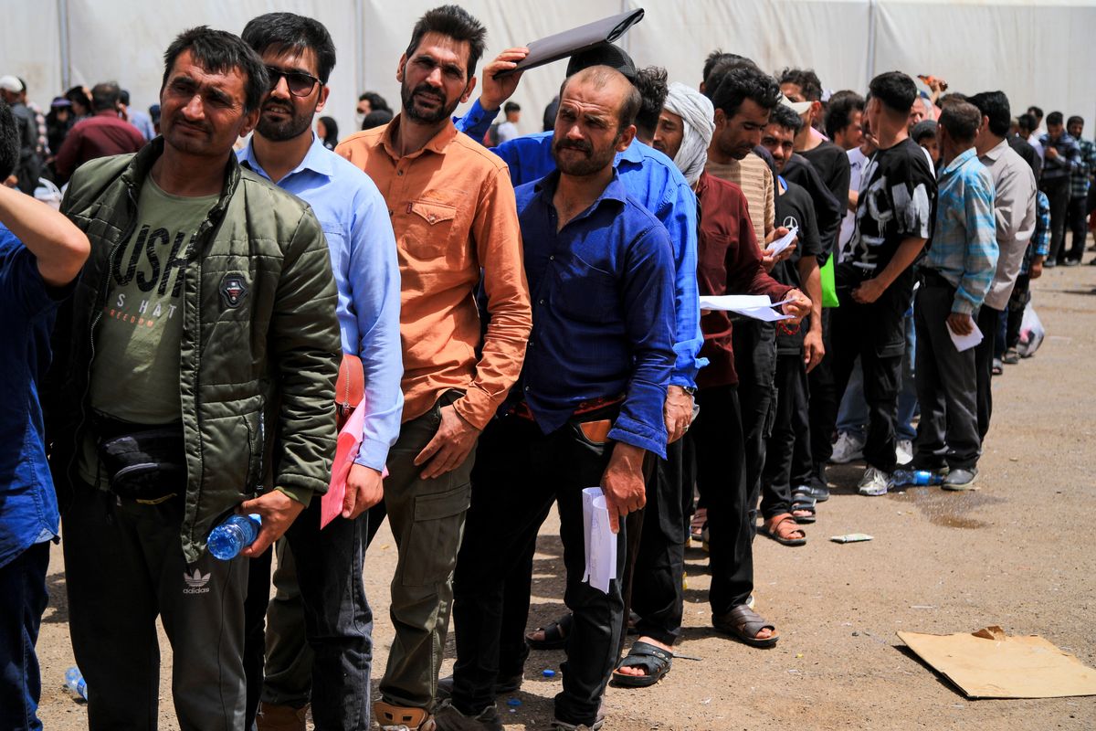 Afghans queue up by the border as Iran cracks down on migrants