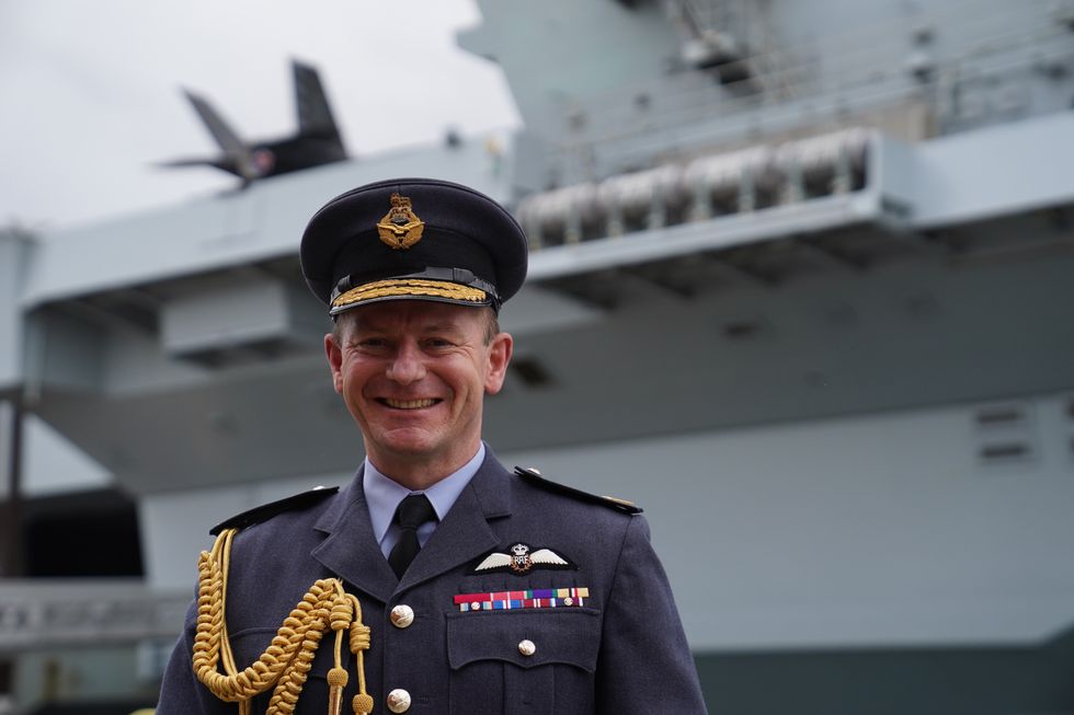 Air Chief Marshal Sir Mike Wigston, Chief of the Air Staff in front of HMS Queen Elizabeth