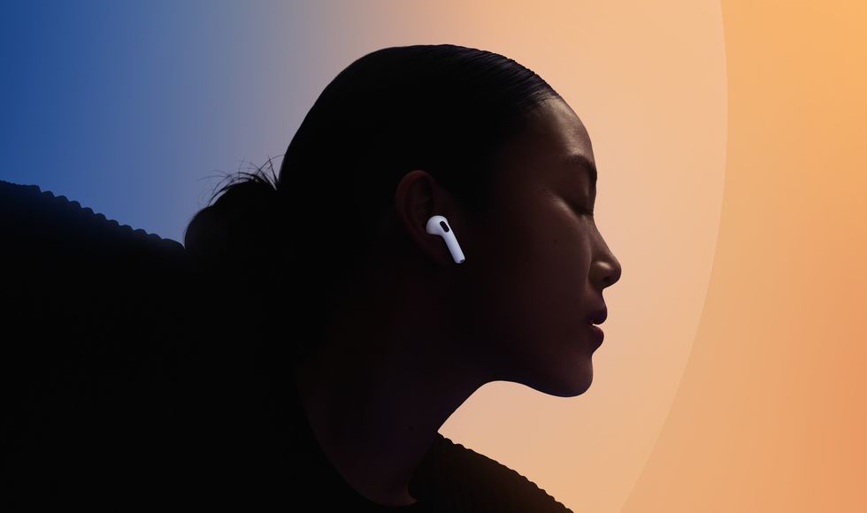 airpods 4 in someones ear with the colourful background