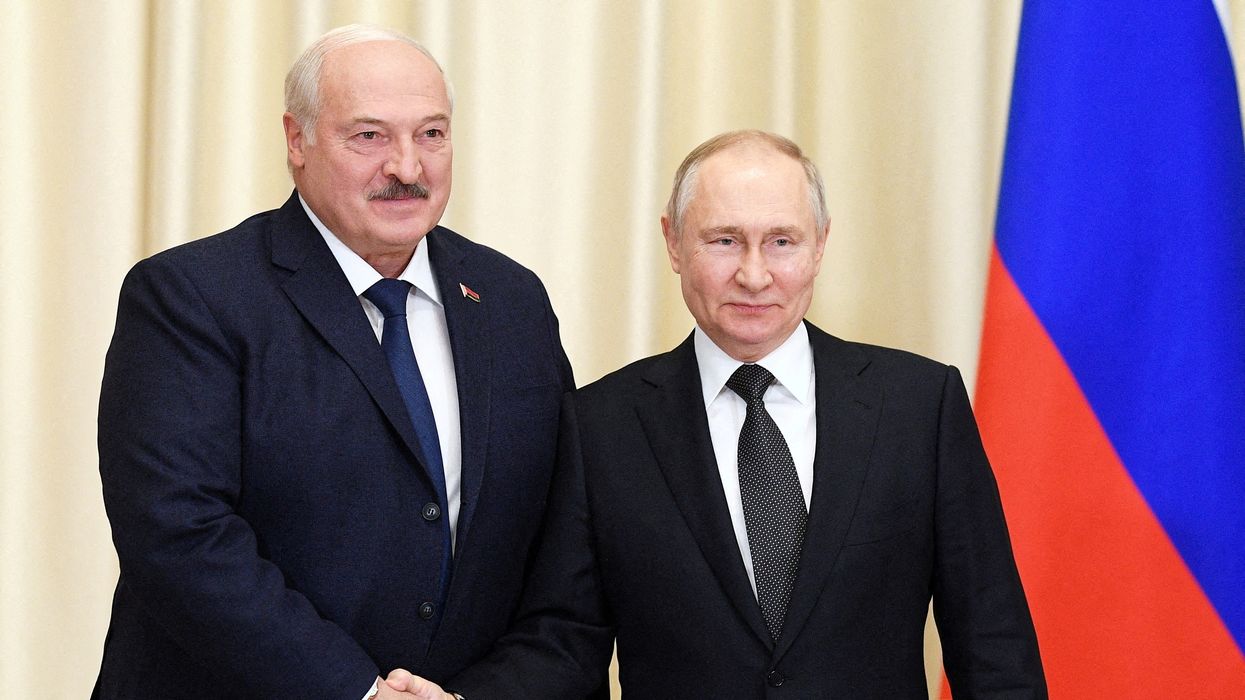 Alexander Lukashenko and Vladimir Putin shake hands