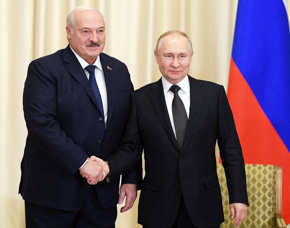 Alexander Lukashenko and Vladimir Putin shake hands
