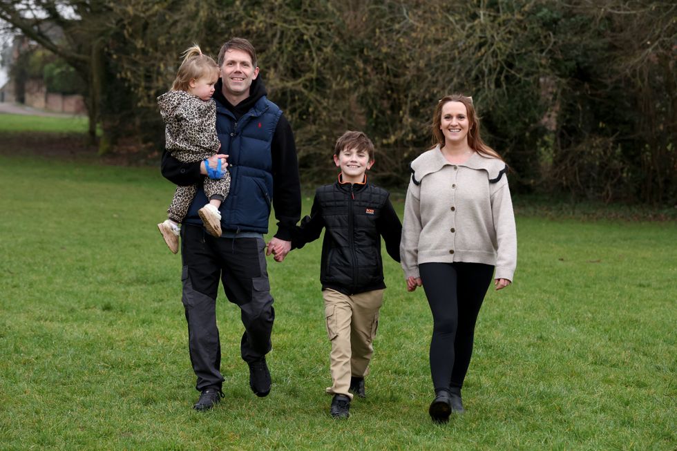 Alfie Phillips with his sister Matilda, his mother Laura Ducker and her partner Scot Phillips at their home near Northampton