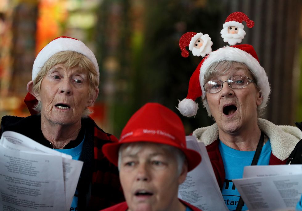 Alice McGregor, (left) and Renee Confrey (right) members of Memory Lane Choir, a choir for older people that welcomes members living with dementia, during their Christmas carols recital at Busaras in Dublin.