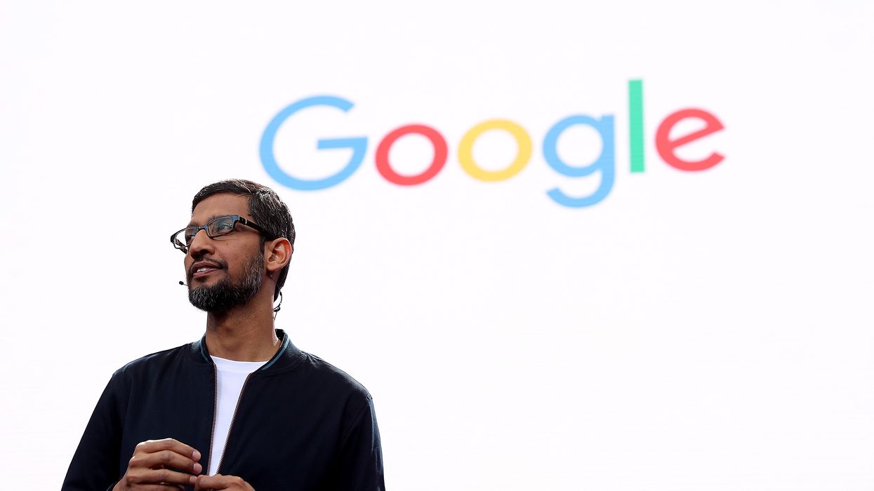 alphabet inc boss sundar pichai speaking during google io developer conference in front of the google logo