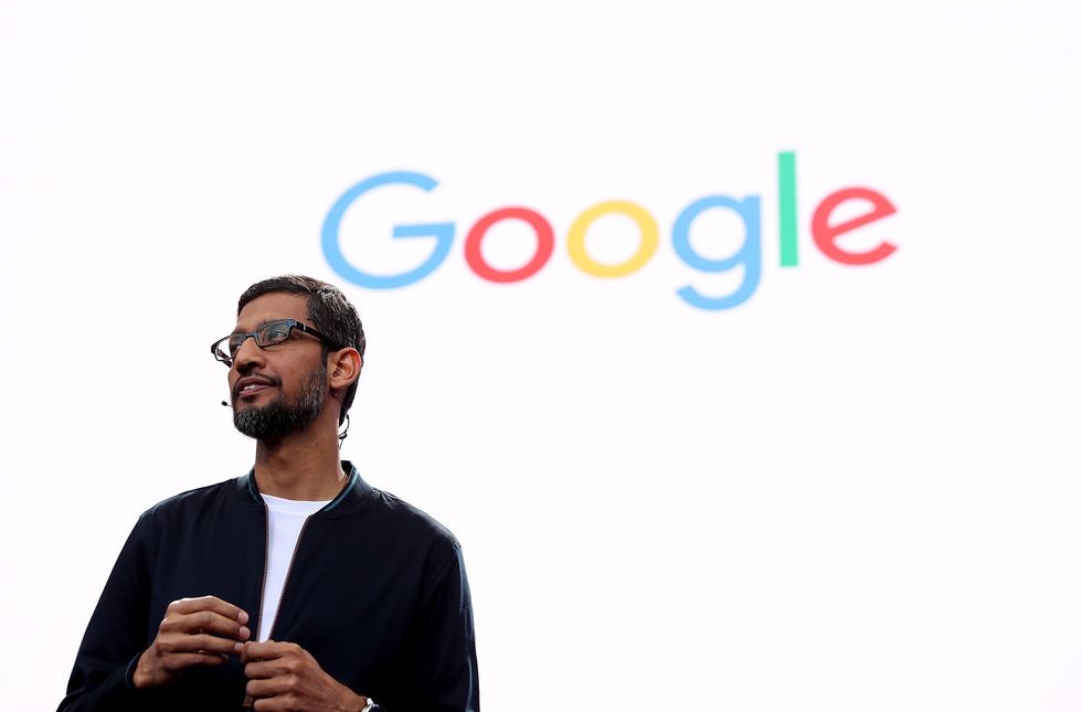 alphabet inc boss sundar pichai speaking during google io developer conference in front of the google logo