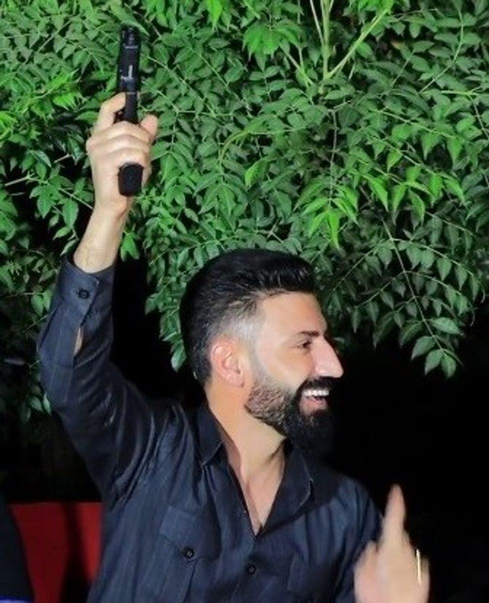 Amanj Hasan Zada holding a gun