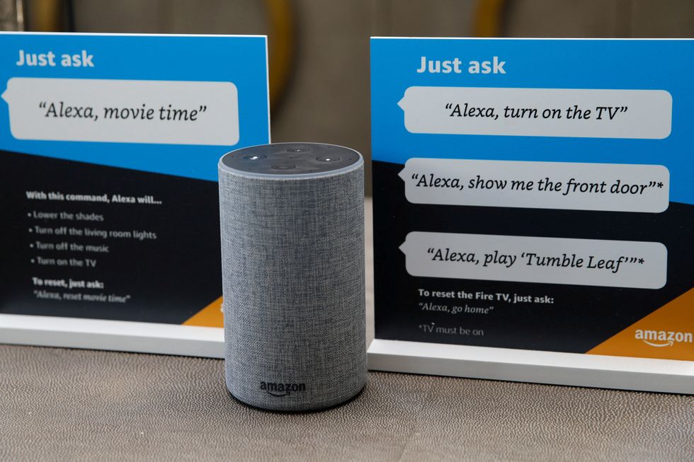 amazon alexa speaker with example prompts on cards around it