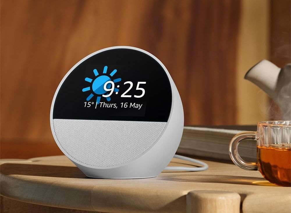 amazon echo spot alarm clock pictured on the side with a cup of tea