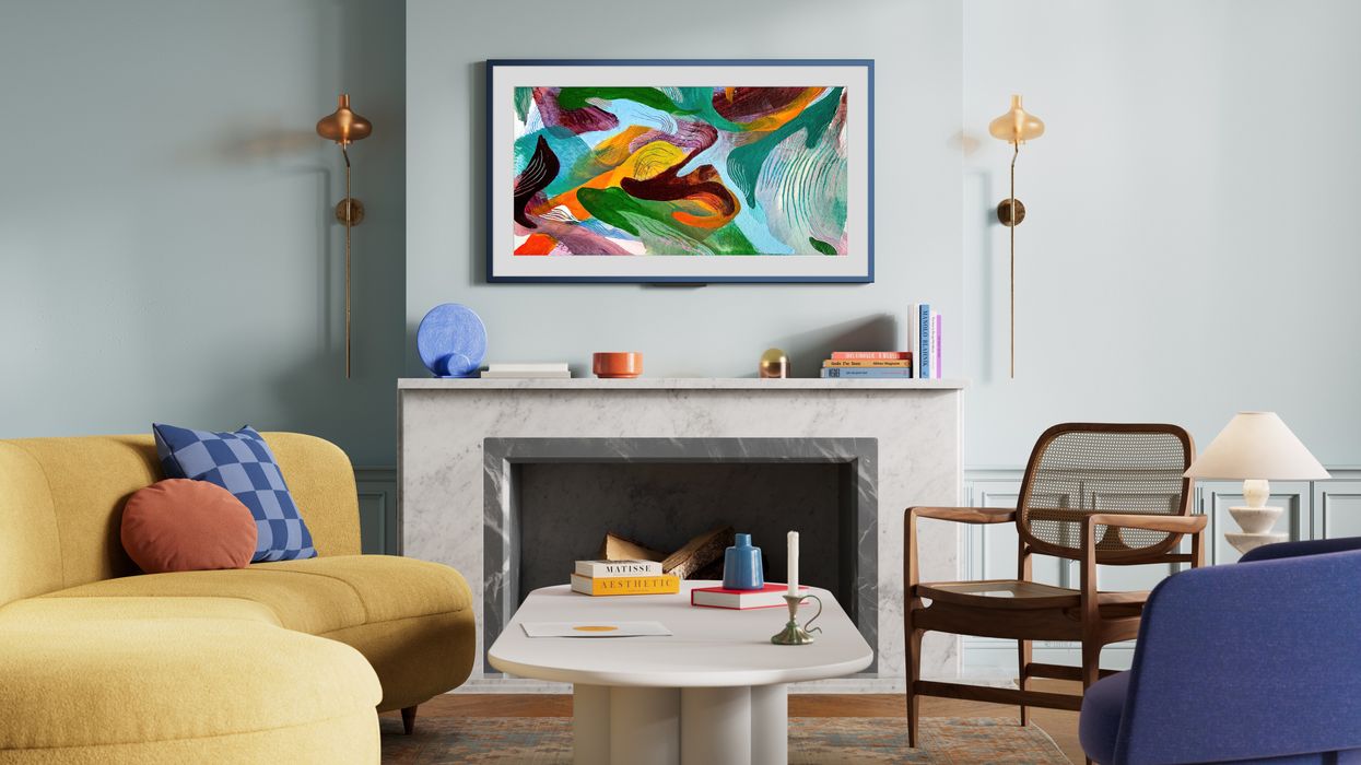 Amazon Ember Artline pictured on the wall with colourful artwork shown on-screen