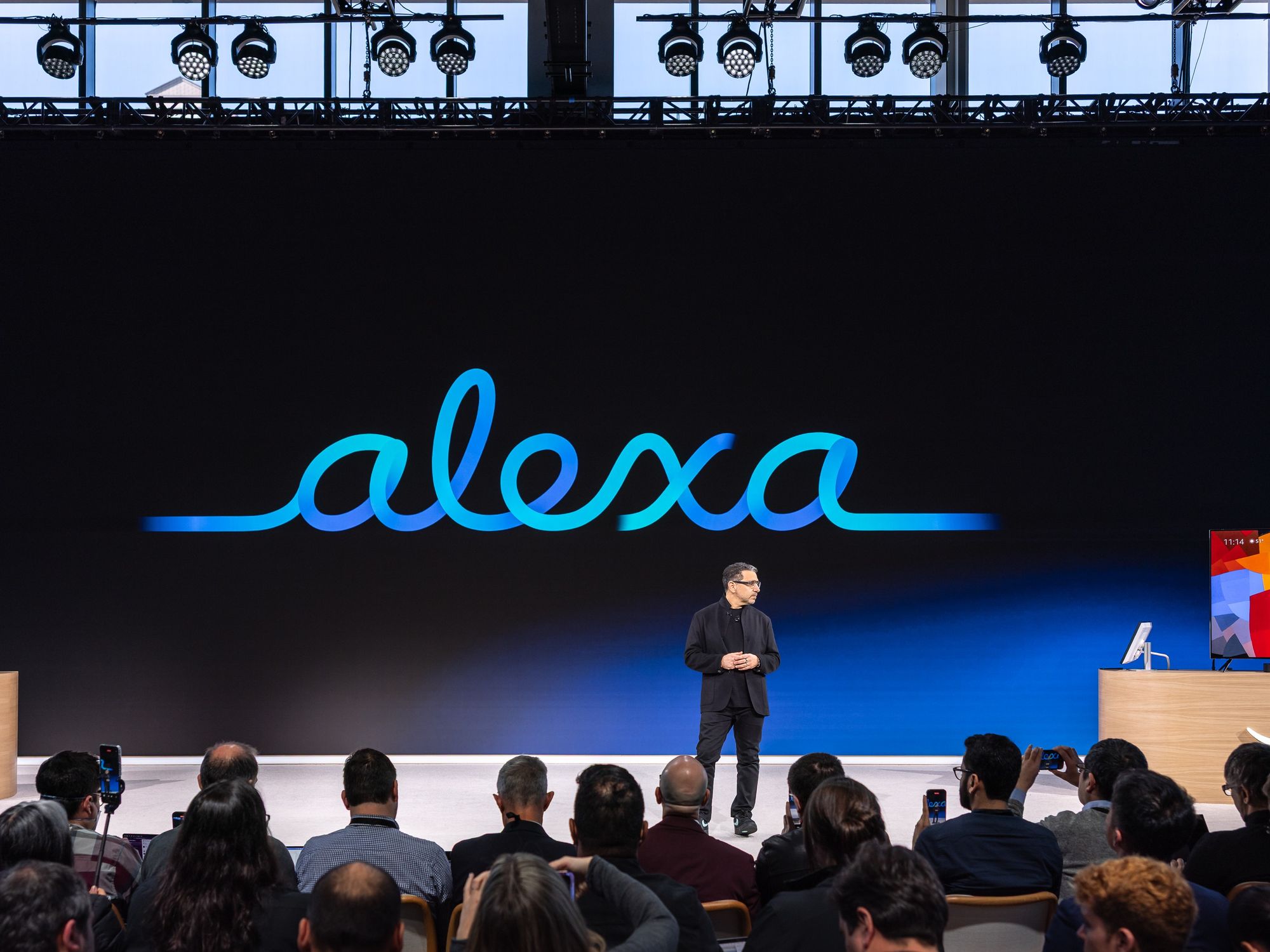 Amazon executive Panos Panay pictured on-stage discussing the latest products and Alexa+