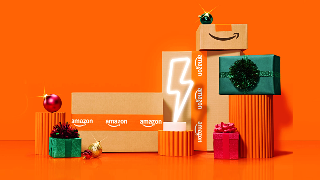 Amazon shipping boxes and gift in front of an orange background