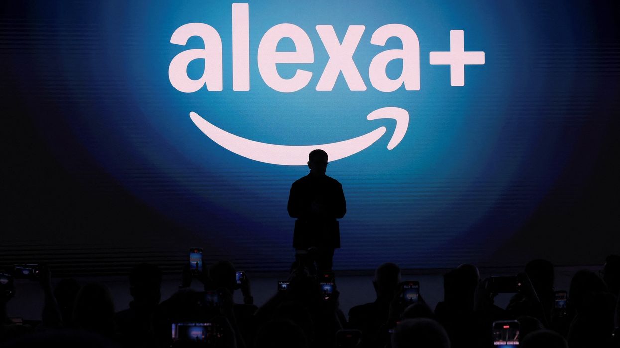 amazon vice president panos panay pictured standing on stage with the alexa plus logo in the background
