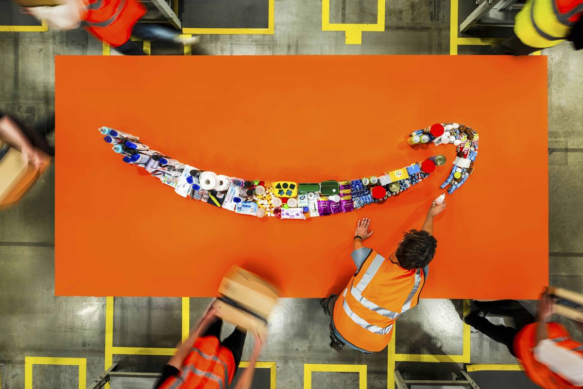 amazon works lay out household products in the shape of the company's smile logo