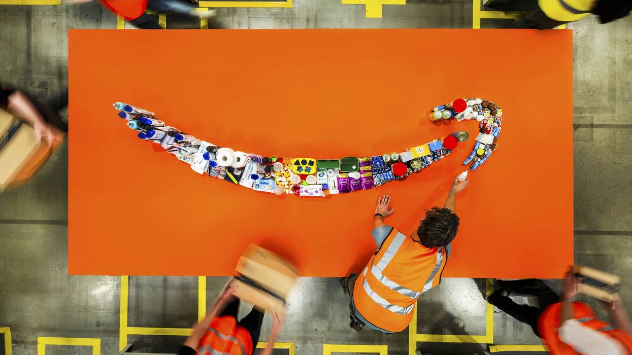 amazon works lay out household products in the shape of the company's smile logo
