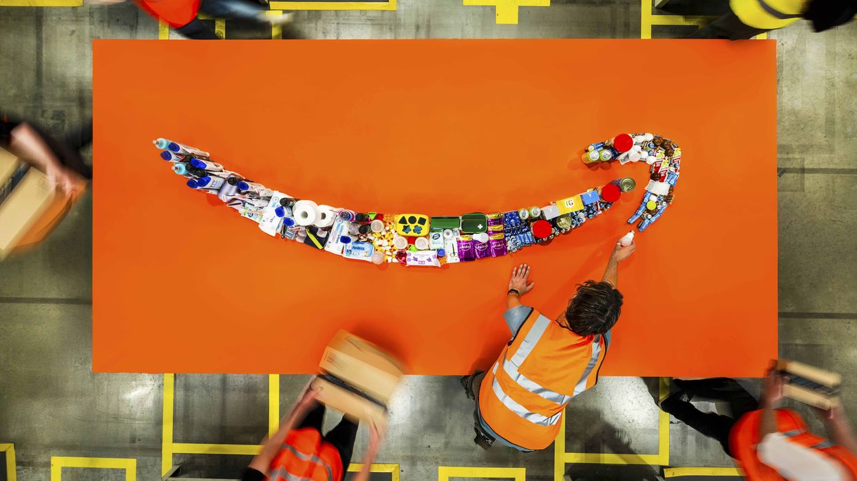 amazon works lay out household products in the shape of the company's smile logo