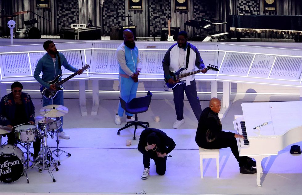 American Football  - NFL - Super Bowl LVI Halftime Show - Cincinnati Bengals v Los Angeles Rams - SoFi Stadium, Inglewood, California, United States - February 13, 2022  Eminem takes a knee alongside Dr Dre as they perform during the halftime show REUTERS/Mario Anzuoni