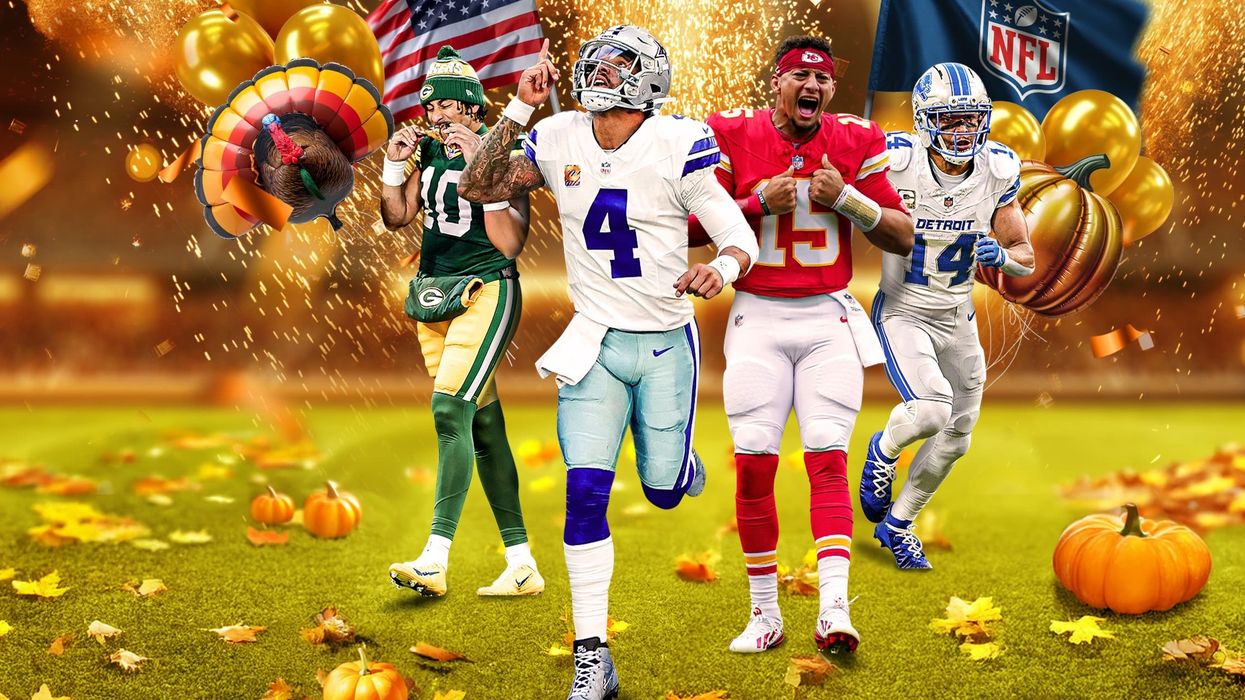 American football players in front of Thanksgiving decorations