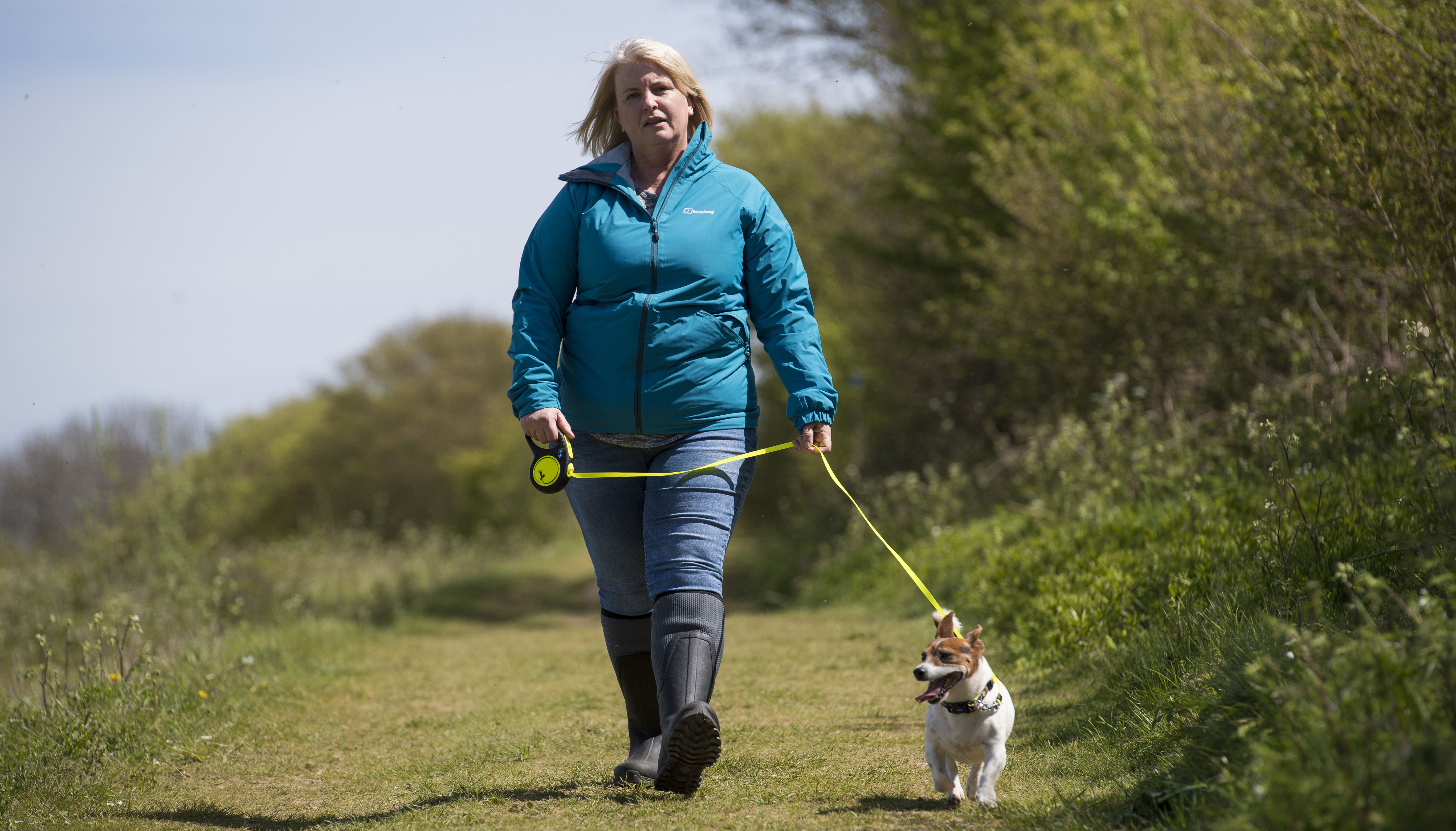 An actress playing the role of PCSO Julia James walks her Jack Russell dog Toby.