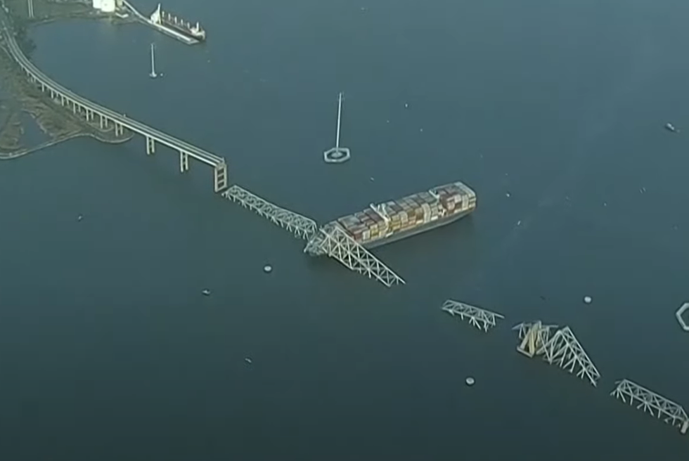 An aerial image of the container ship and debris from the bridge