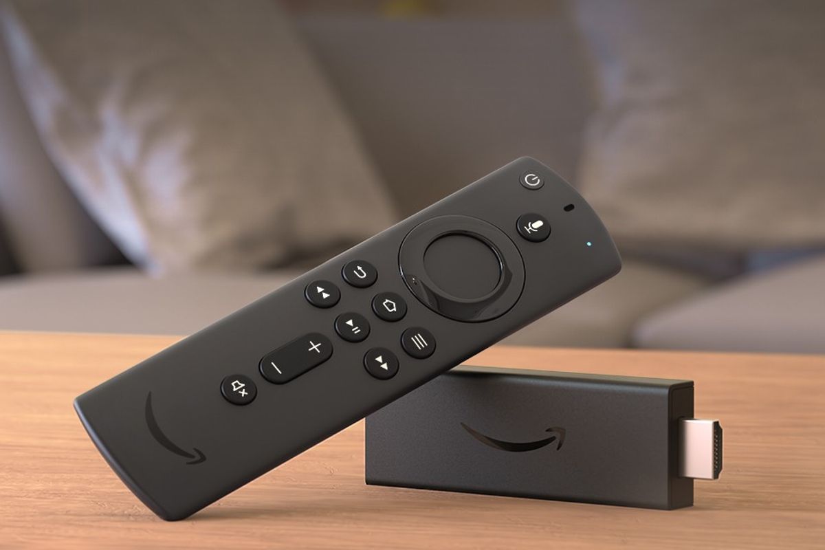 an amazon fire tv stick is pictured lying on its side on a table 
