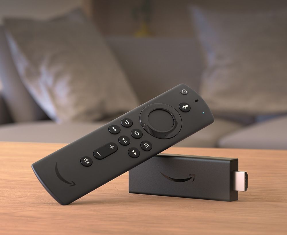 an amazon fire tv stick is pictured lying on its side on a table