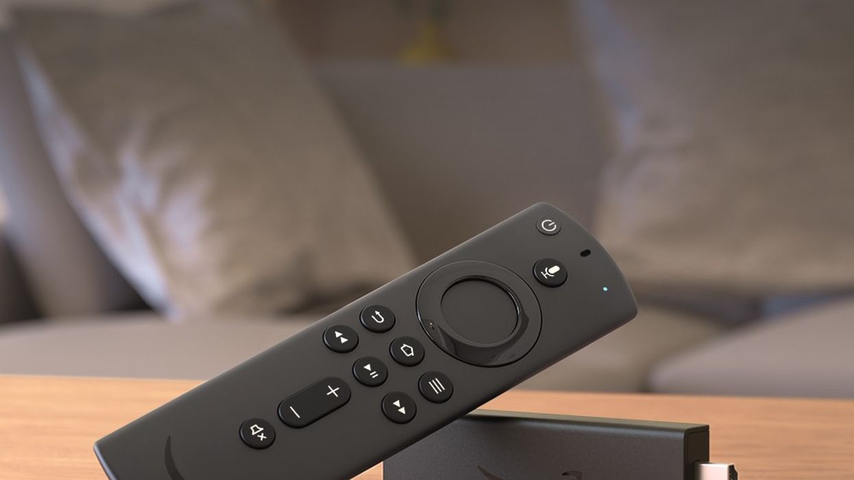 an amazon fire tv stick is pictured lying on its side on a table