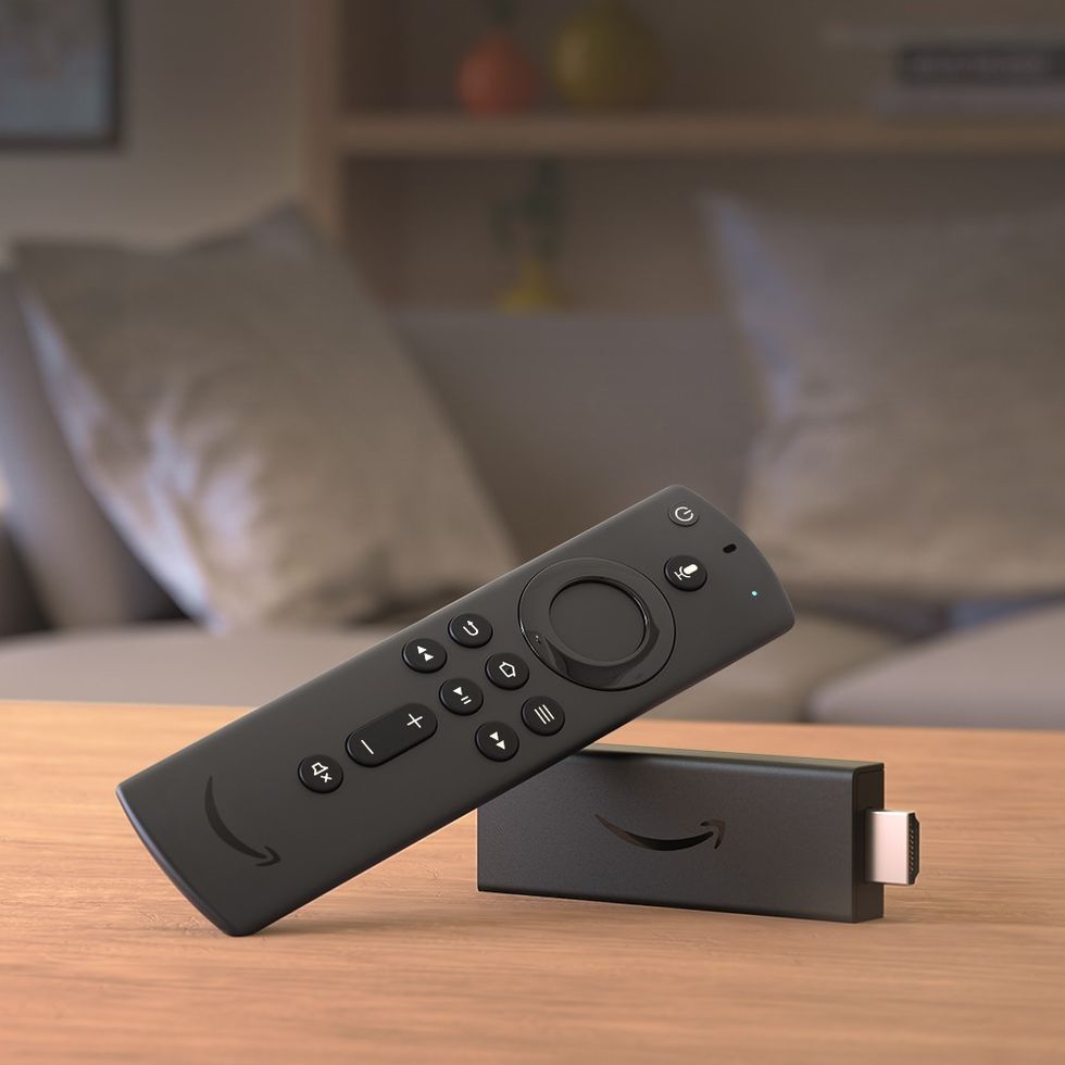 an amazon fire tv stick is pictured lying on its side on a table 