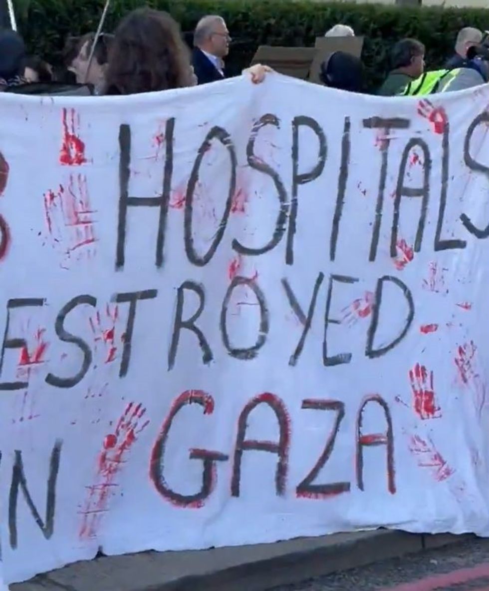 An anti-Israel banner with red hand prints on
