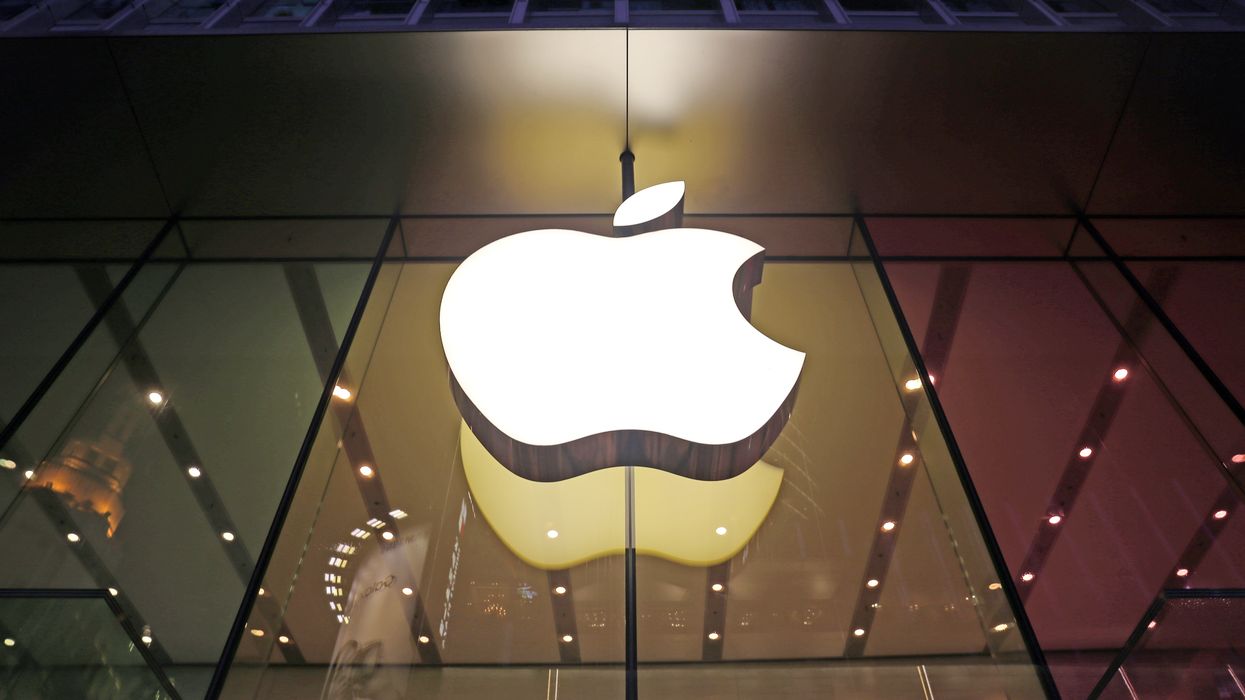 an apple logo hanging outside one of the iphone makers' stores