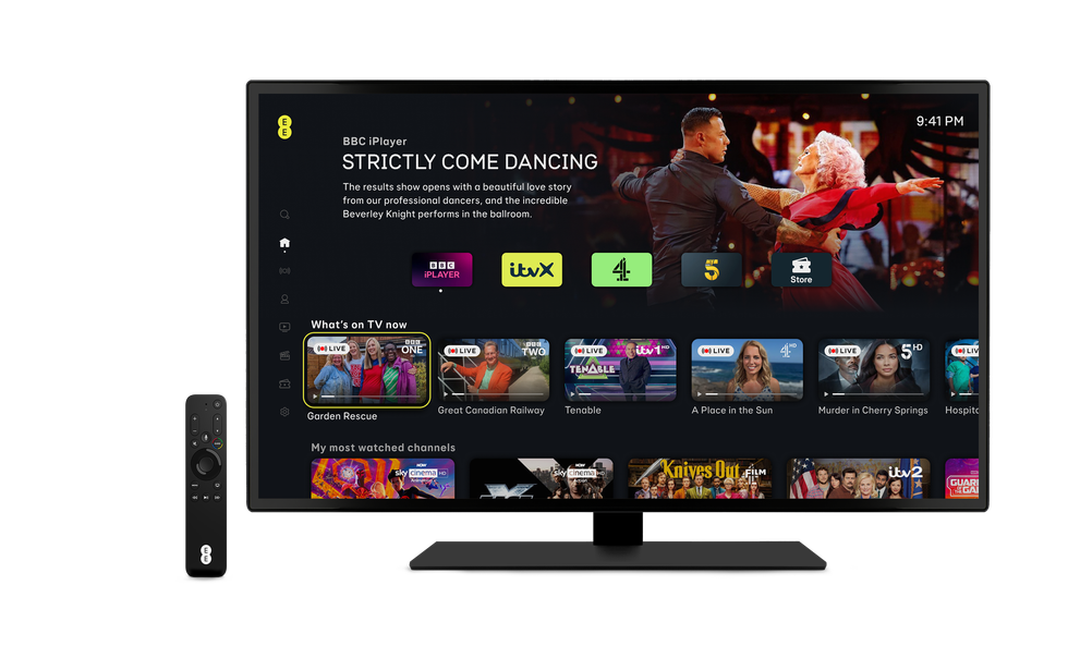 an apple tv remote control from ee alongside a television displays the ee tv menu