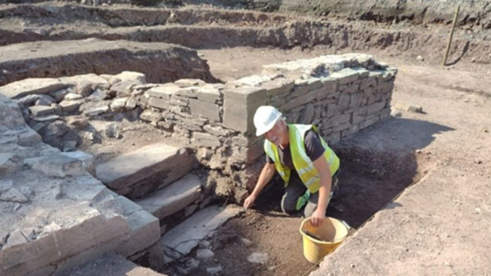 An archaeologist works on the Island House dig site
