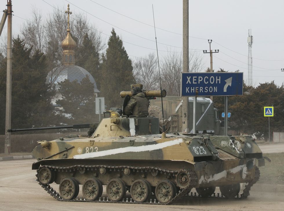 An armoured vehicle drives along a street, after Russian President Vladimir Putin authorised a military operation in eastern Ukraine, in the town of Armyansk, Crimea, February 24, 2022. REUTERS/Stringer