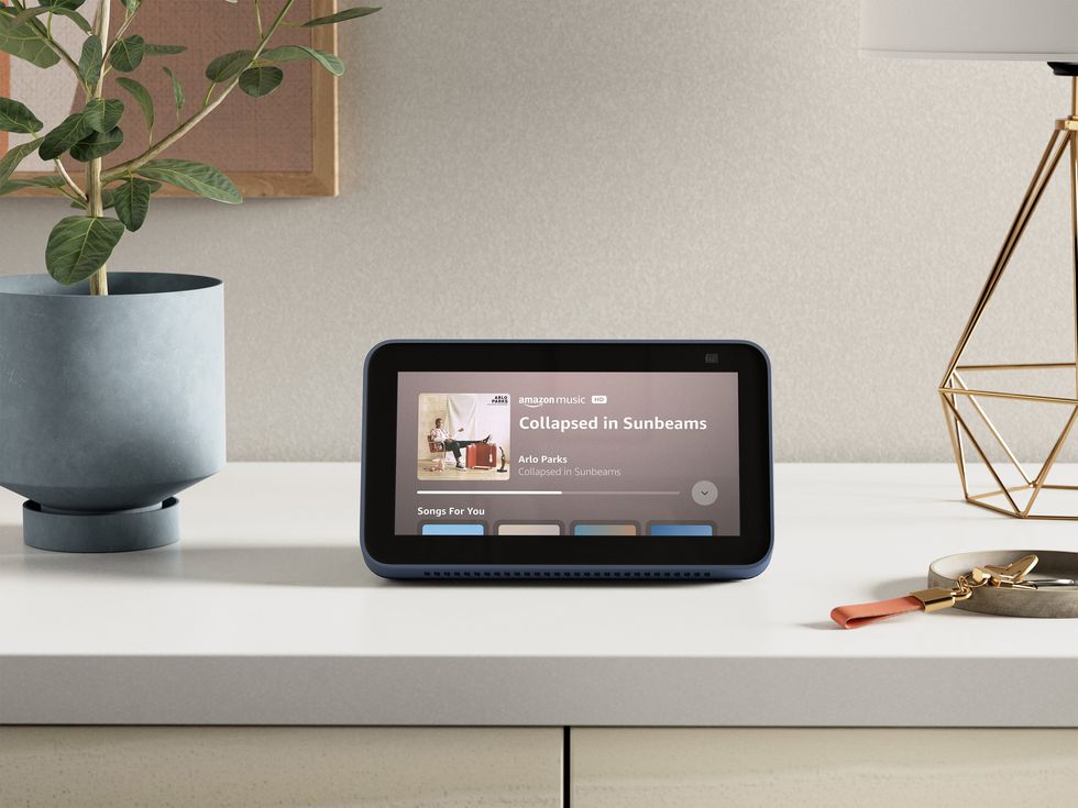an echo show is pictured on a tabletop playing music