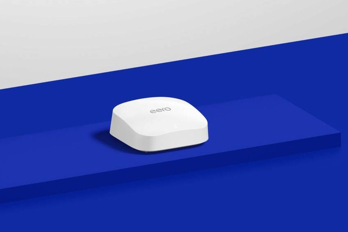an eero pro router is pictured sat on a blue counter  