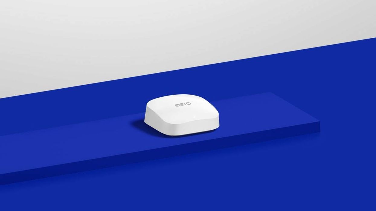 an eero pro router is pictured sat on a blue counter