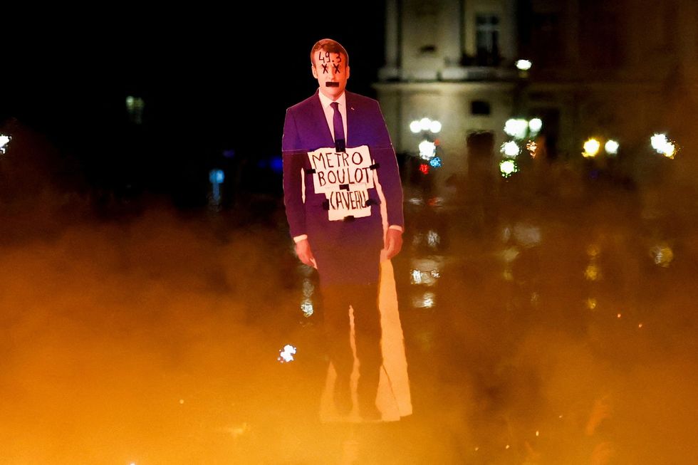 An effigy of Macron burns as protests continues in Paris